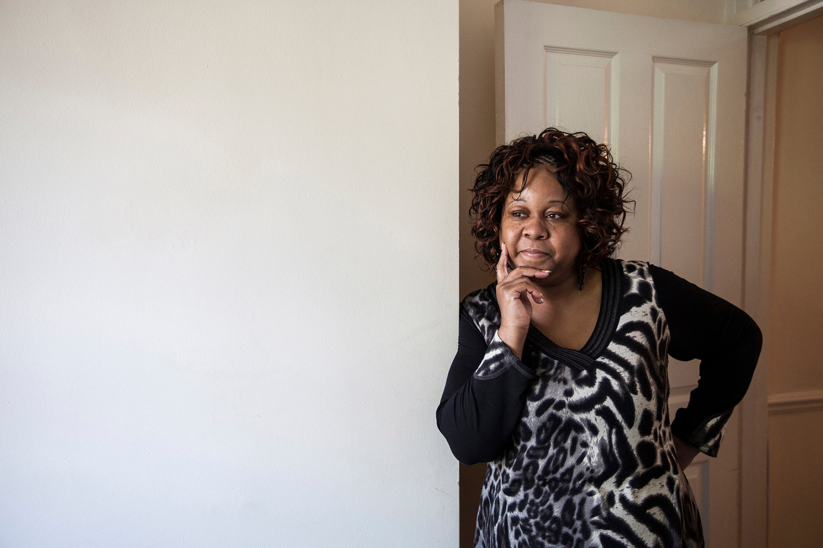 Woman standing in a room with a neutral background