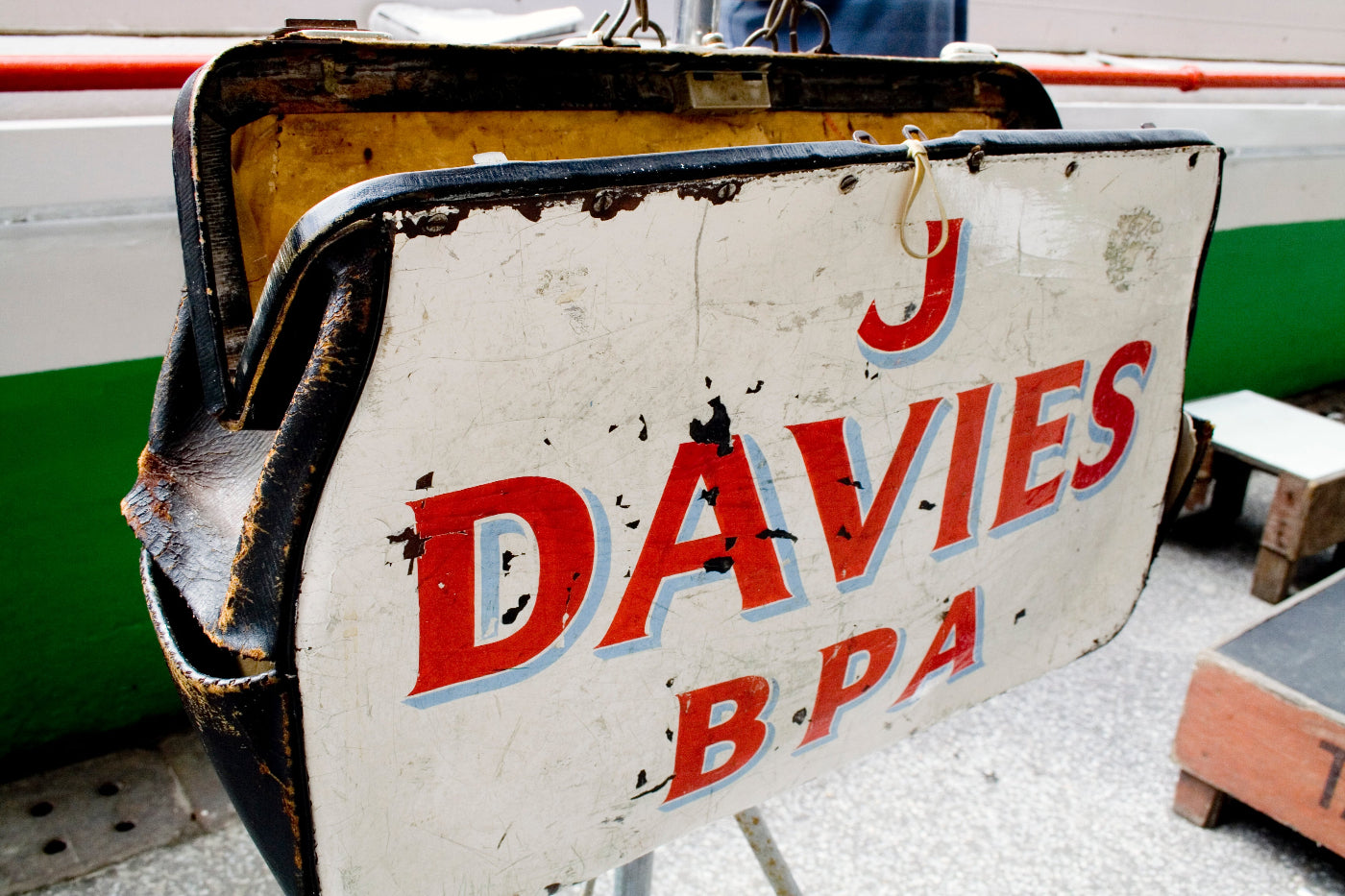 Large leather bag owned by a bookie with 'J Davies BPA' text on a blurred background