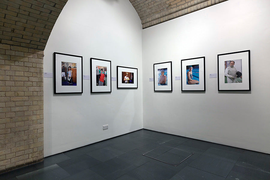 Art gallery with framed photographs on white walls.